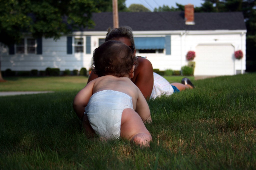 baby crawling on lawn