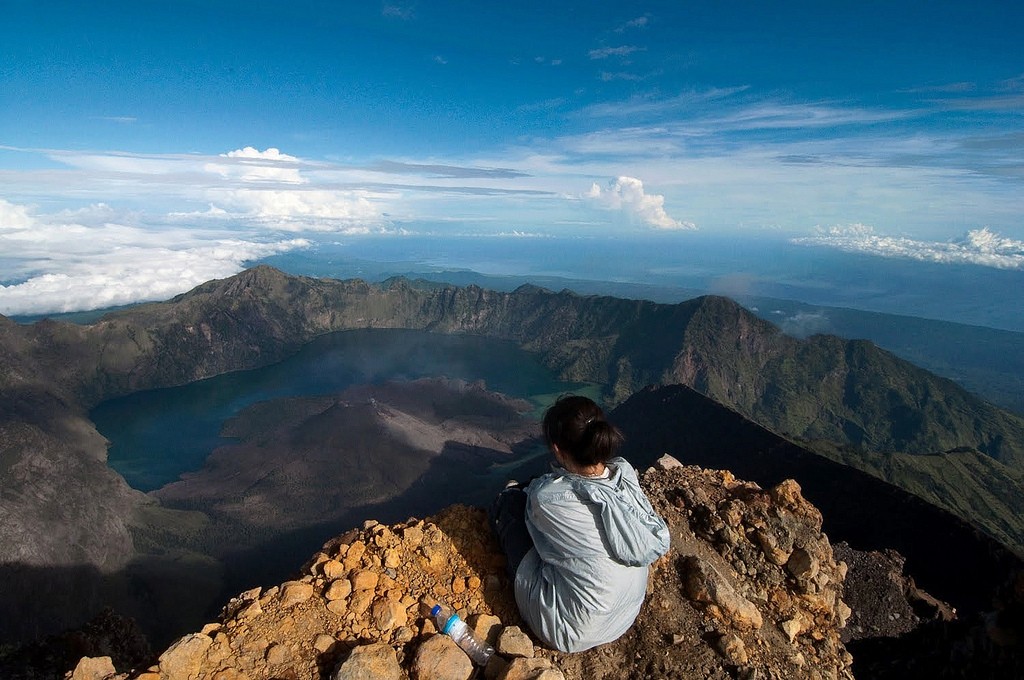 picture of woman atop hill with spectacular view