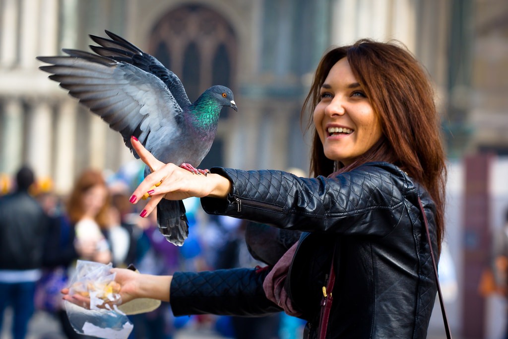 Woman smiling holding bird